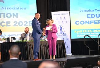 Minister of Education, Skills, Youth and Information, Senator Dr. the Hon. Dana Morris Dixon, accepts a donation form for a Critical Illness Trust Fund from President of the Jamaica Teachers' Association (JTA), Dr. Mark Smith, during day one (April 22) of a three-day JTA Education Conference 2025, being held at Ocean Coral Spring in Trelawny. Expansion and Upgrade of Labs in Technical High Schools Photo: Okoye Henry Minister of Education, Skills, Youth and Information, Senator Dr. the Hon. Dana Morris Dixon