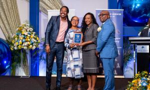 Receiving the Golden Torch Award from State Minister for Education and Youth, Marsha Smith for her 45 years of service to education. Participating also are Opposition Spokesman on Education, Damion Crawford (left) and JTA President, Leighton Johnson (right).