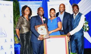 Miss Dorane Dixon (centre) shares the proud moment with her father, Mr. Doran Dixon (second left) who was named the 55th recipient of the Jamaica Teachers' Association Roll of Honour Award on November 20. They are joined by (from left:): Pastor Doreen Williams of the Church of God of Prophecy in Church Pen, Old Harbour; Mr. Desmond Rose, who is Mr. Dixon's lifelong friend; and Deacon Gayford Williams, also from the Church of God of Prophecy.