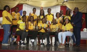 The winning Manchester Netball team for the 2025 competition after being presented with their trophy by IPP of the JTA Mr. Leighton Johnson. At left is Regional Officer Georgia Waugh Richards