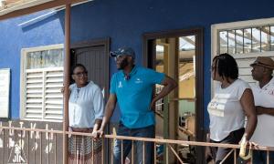 Brompton primary - President and team looks at the damage to a school from a shaded vantage point